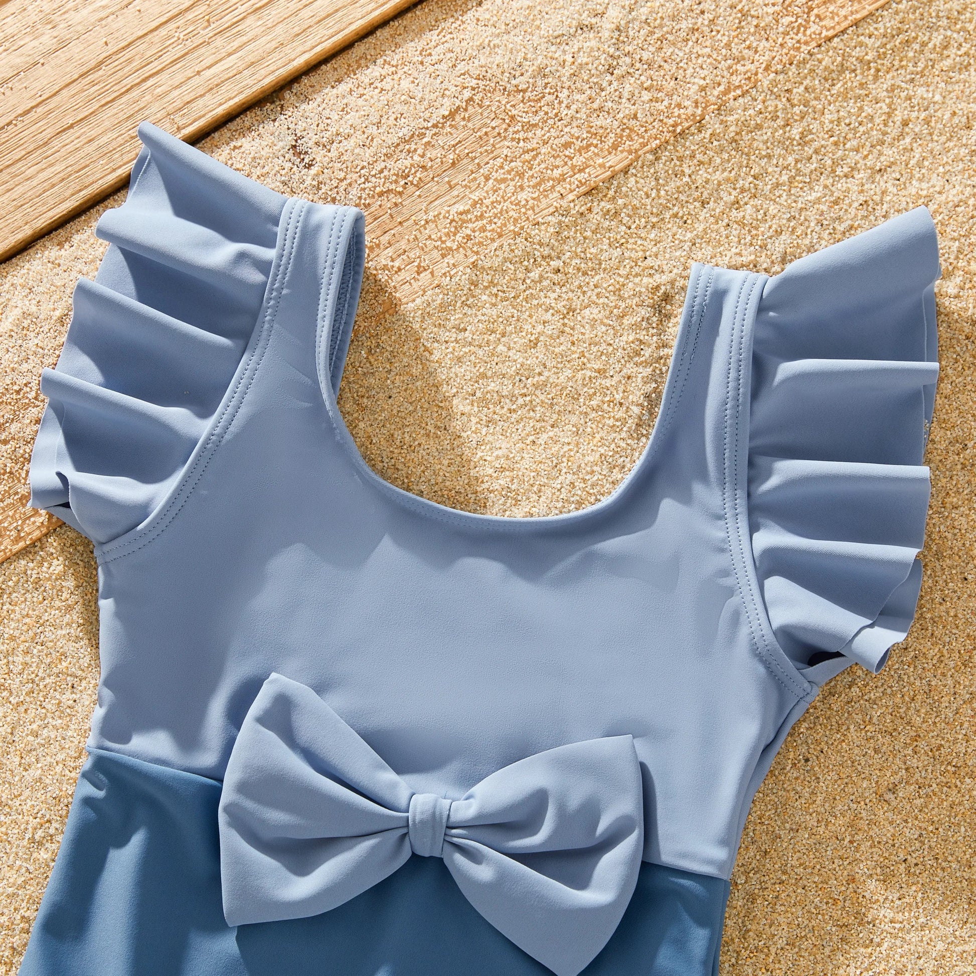 Stylish blue family swimwear, featuring a modern bow design for summer