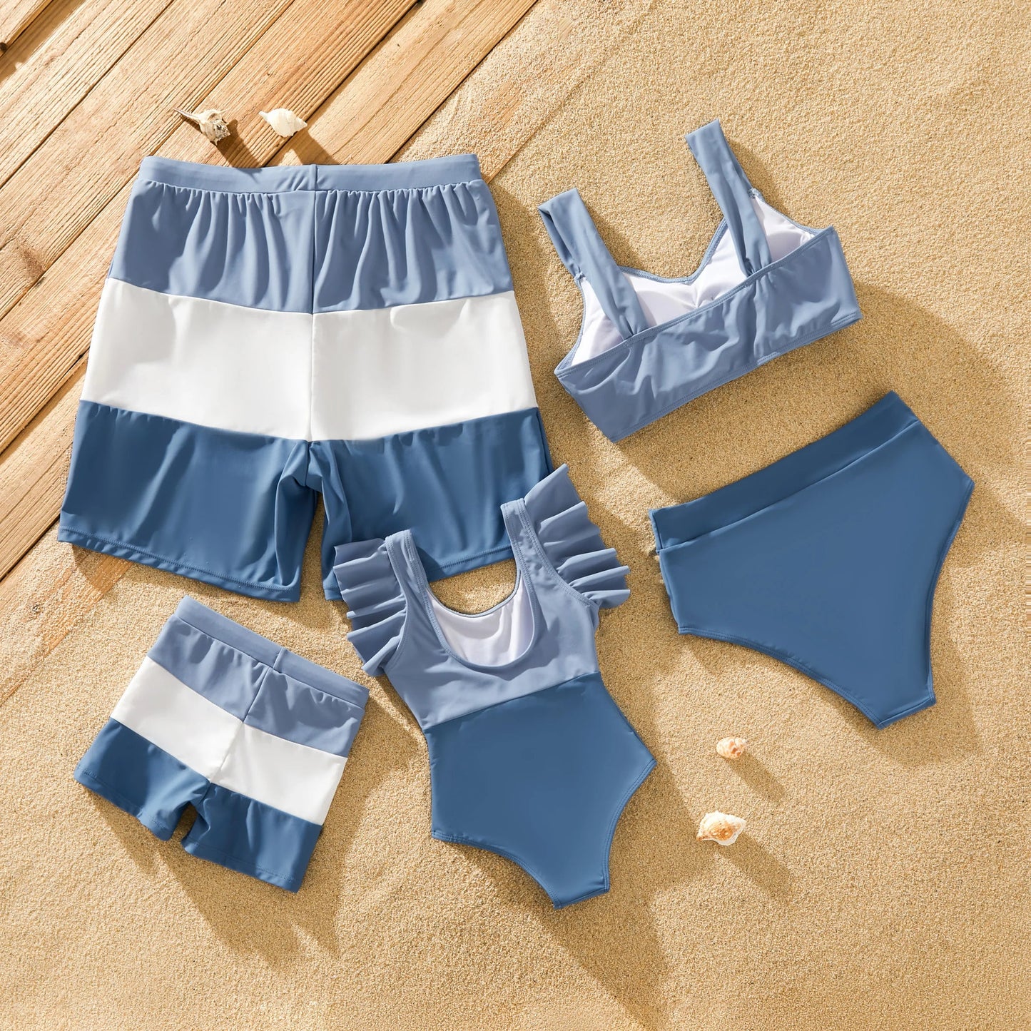 Family in blue matching swimsuits with bow-knot detail, perfect for beach outfits
