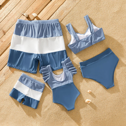 Family in blue matching swimsuits with bow-knot detail, perfect for beach outfits