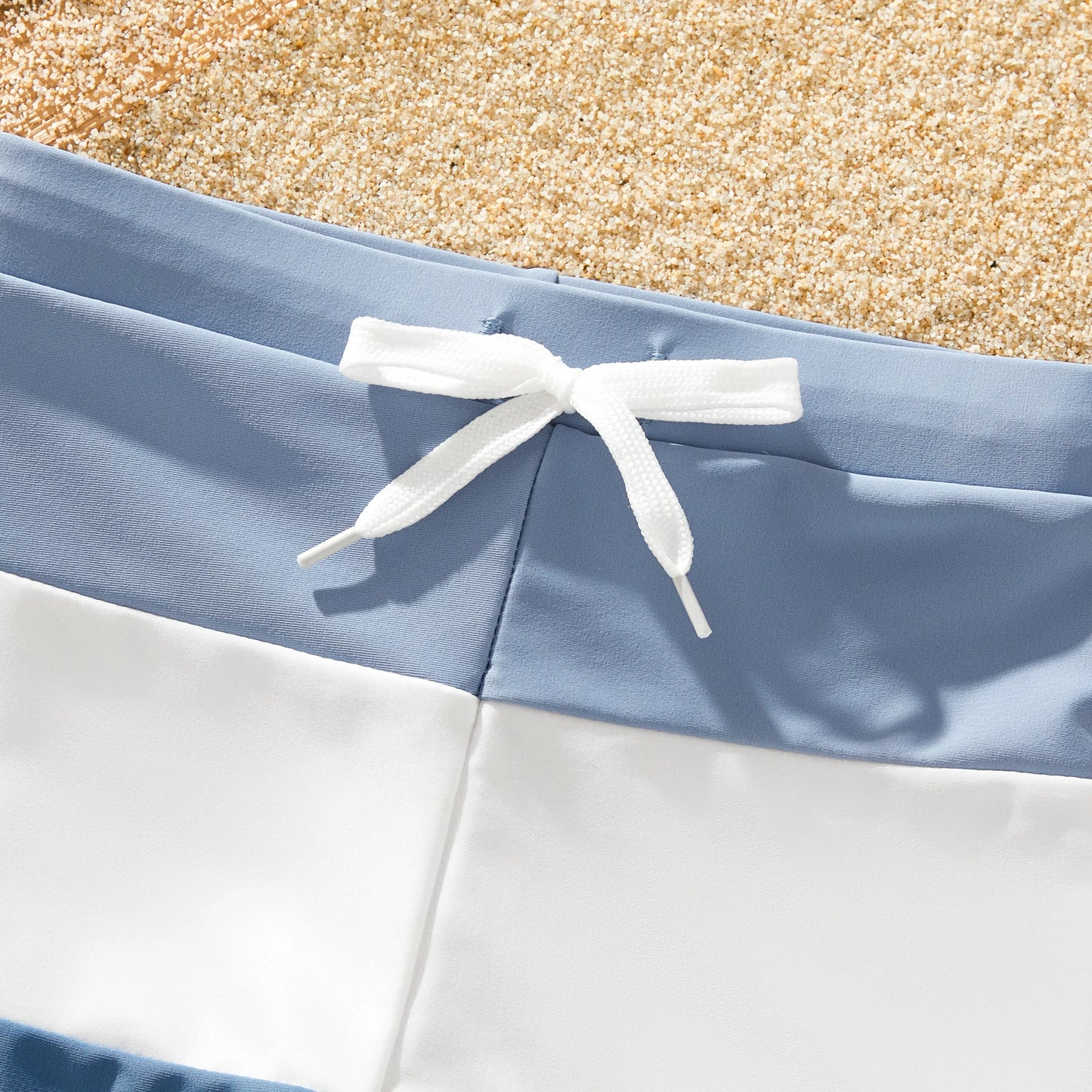 Parents and kids in matching blue family swimwear, ideal for a summer pool party