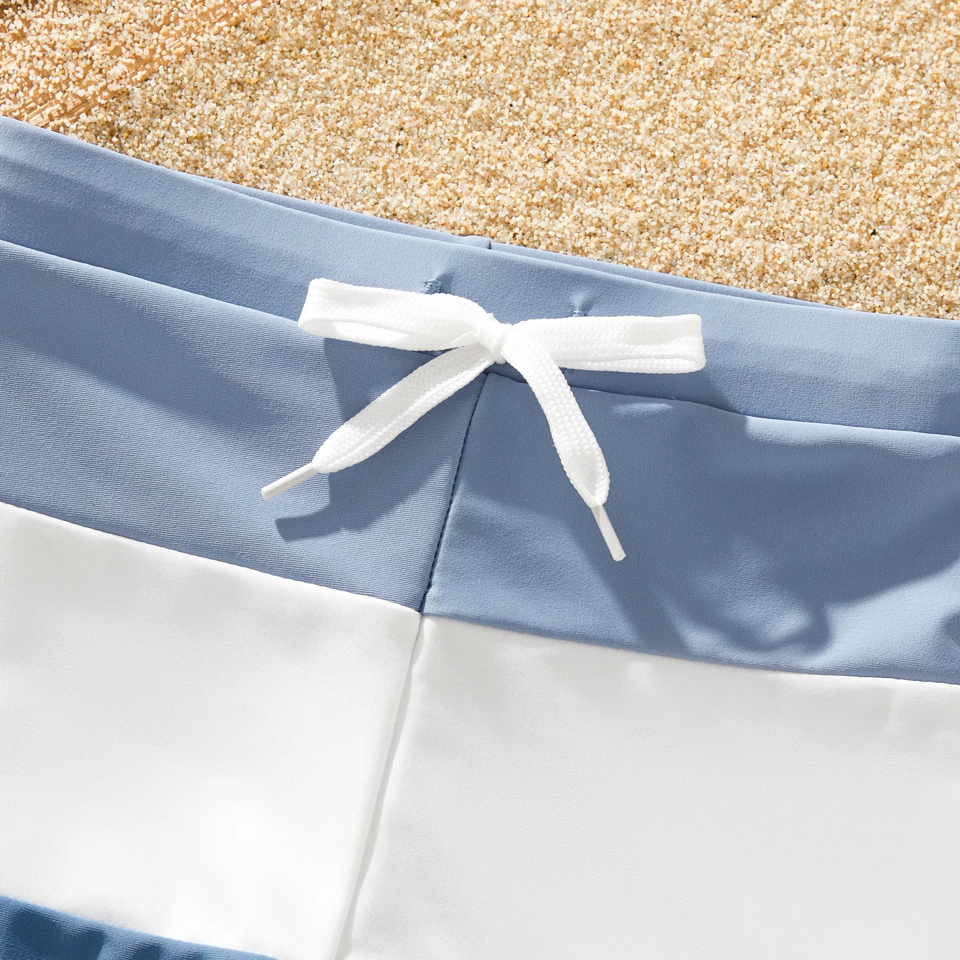Parents and kids in matching blue family swimwear, ideal for a summer pool party