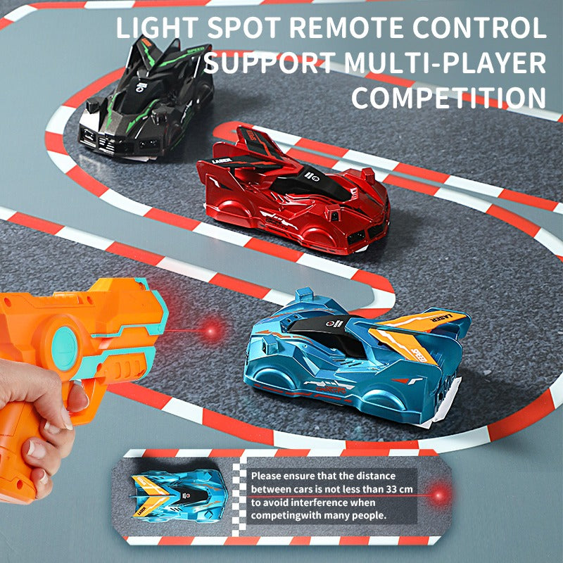 Boy enthusiastically controlling a blue wall climbing toy car with a laser pointer