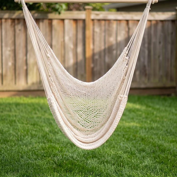 Stylish bohemian tasseled cotton hanging chair, perfect patio decor for outdoor seating & garden relaxation.