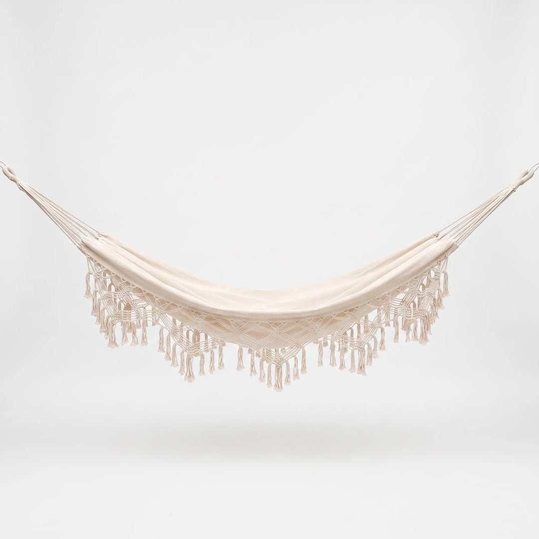 Durable cotton tasseled hanging hammock chair, offering single-person outdoor seating & relaxation for your patio.