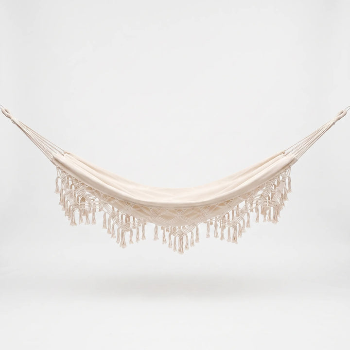 Durable cotton tasseled hanging hammock chair, offering single-person outdoor seating & relaxation for your patio.