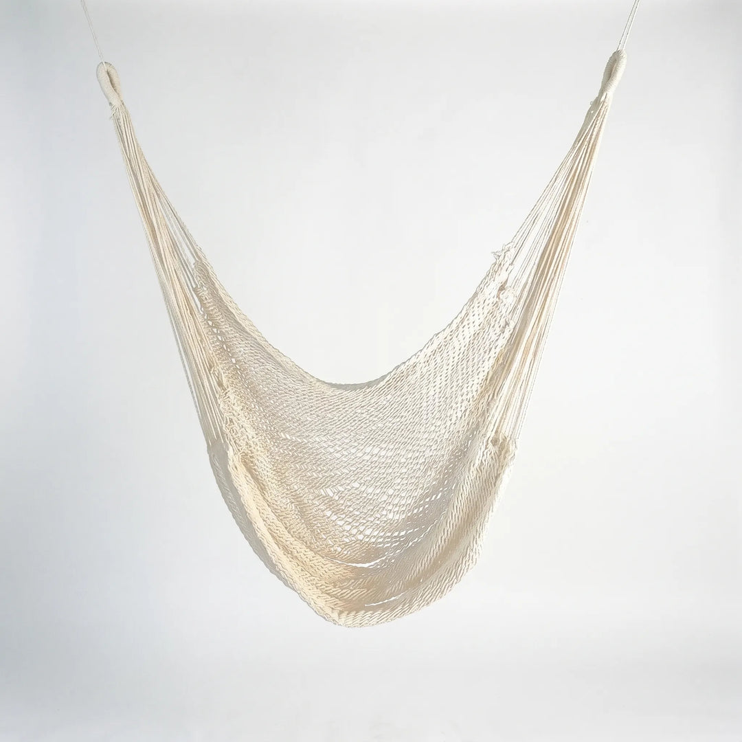 Versatile bohemian tasseled hanging chair or bed for outdoor lounging, perfect garden furniture & patio decor.