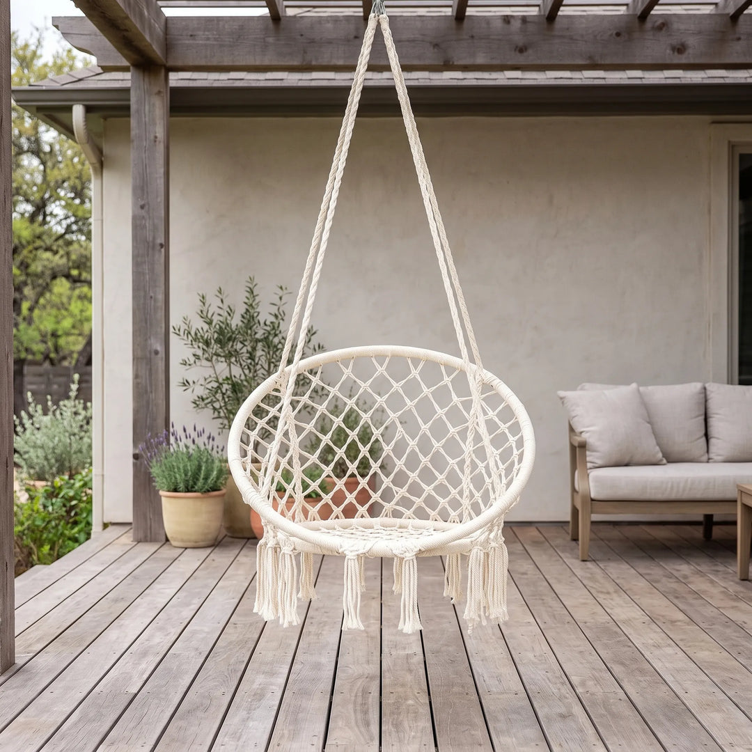 Boho macrame hammock chair for indoor or outdoor relaxation. Hand-woven swing seating with fringe details.