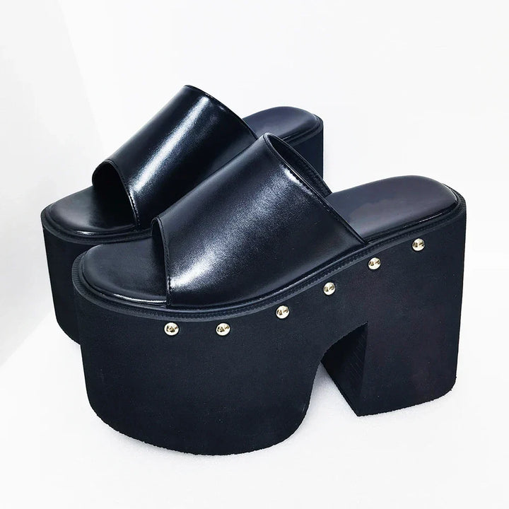Women's bold black platform sandals with a dramatic 5.5-inch block heel, offering a high-fashion, open-toe look.
