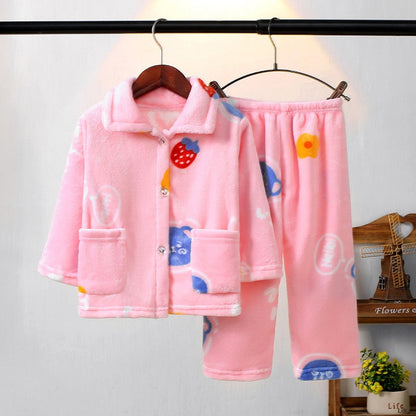 Toddler playing in warm flannel winter pajamas, comfortable long-sleeve sleepwear for kids.