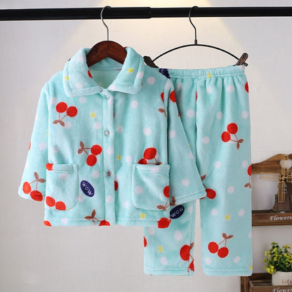 Flat lay of a red plaid flannel pajama set for kids, warm long-sleeve winter sleepwear.
