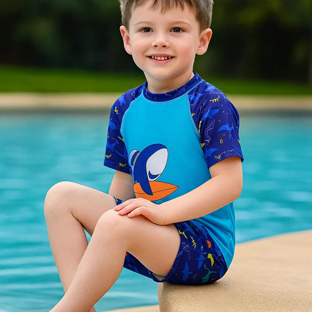 Children's UPF 50+ sun protection swimwear with vibrant jungle animal print, ideal for pool and beach.