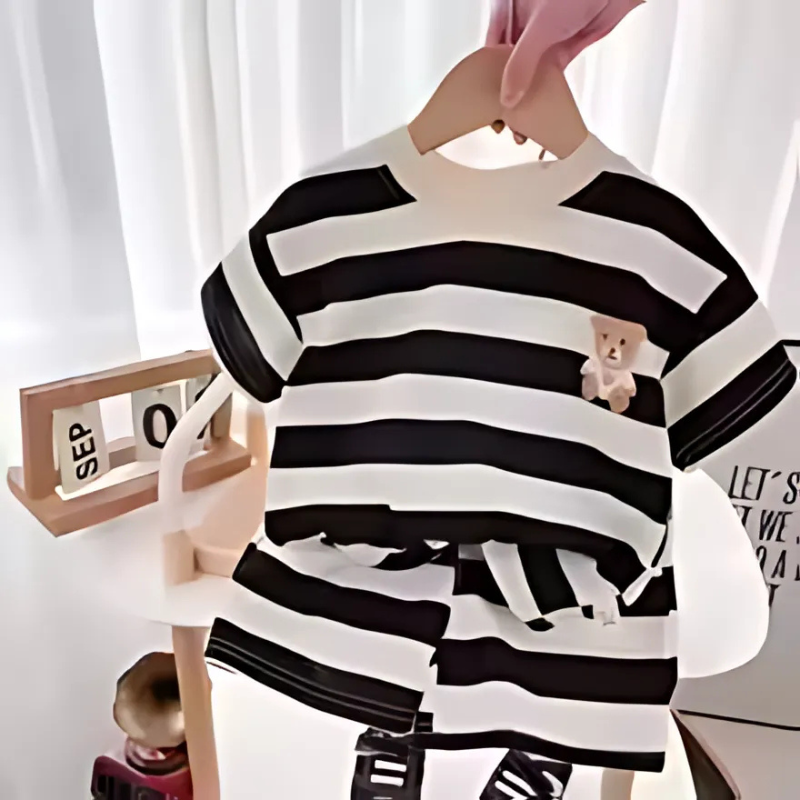 Boy's summer outfit: blue and white striped t-shirt and matching shorts, front view on white background.
