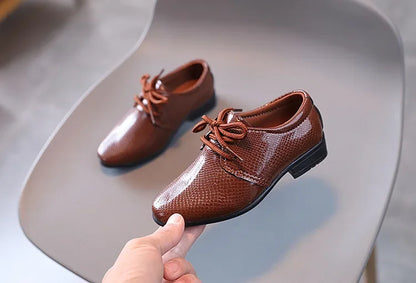 Youth formal black shoes for boys, offering a smart look for any event.