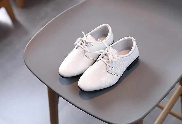 Classic boys' black shoes with laces, suitable for both dressy and school outfits.
