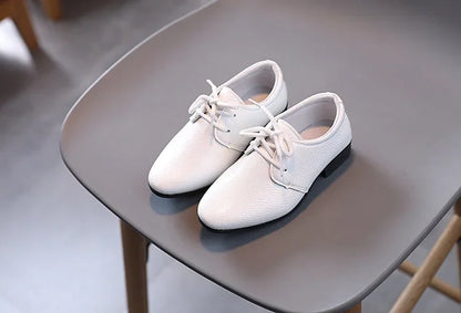 Classic boys' black shoes with laces, suitable for both dressy and school outfits.