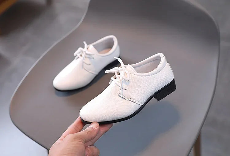 PU leather boys' formal shoes in sleek black, ideal for school and celebration.