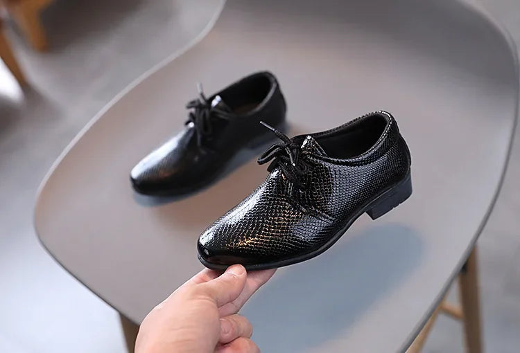 Smart boys' black school shoes, durable and stylish for daily wear.