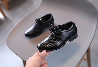 Smart boys' black school shoes, durable and stylish for daily wear.