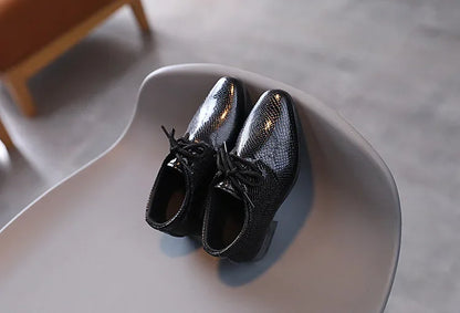 Formal black PU leather shoes for young boys, enhancing any formal outfit.