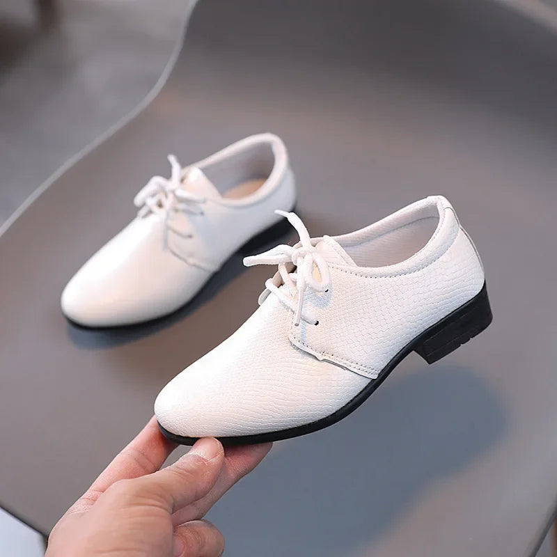 Classic black boys' dress shoes, perfect for formal events and school wear.