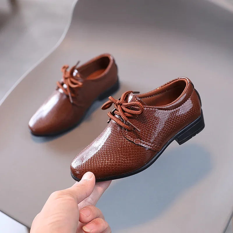 Youth PU leather formal shoes in black, suitable for school and special occasions.