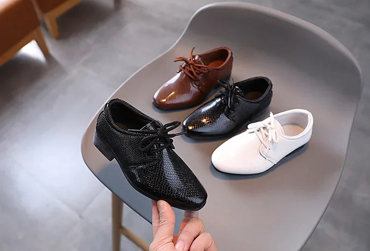 Boys' black wedding shoes, comfortable and formal for special day events.