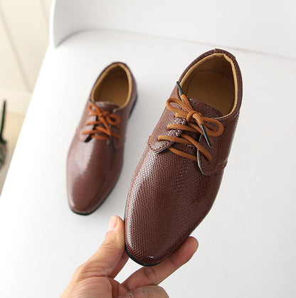 Stylish boys' dress shoes, black crocodile leather, slip-on comfort, perfect for school.