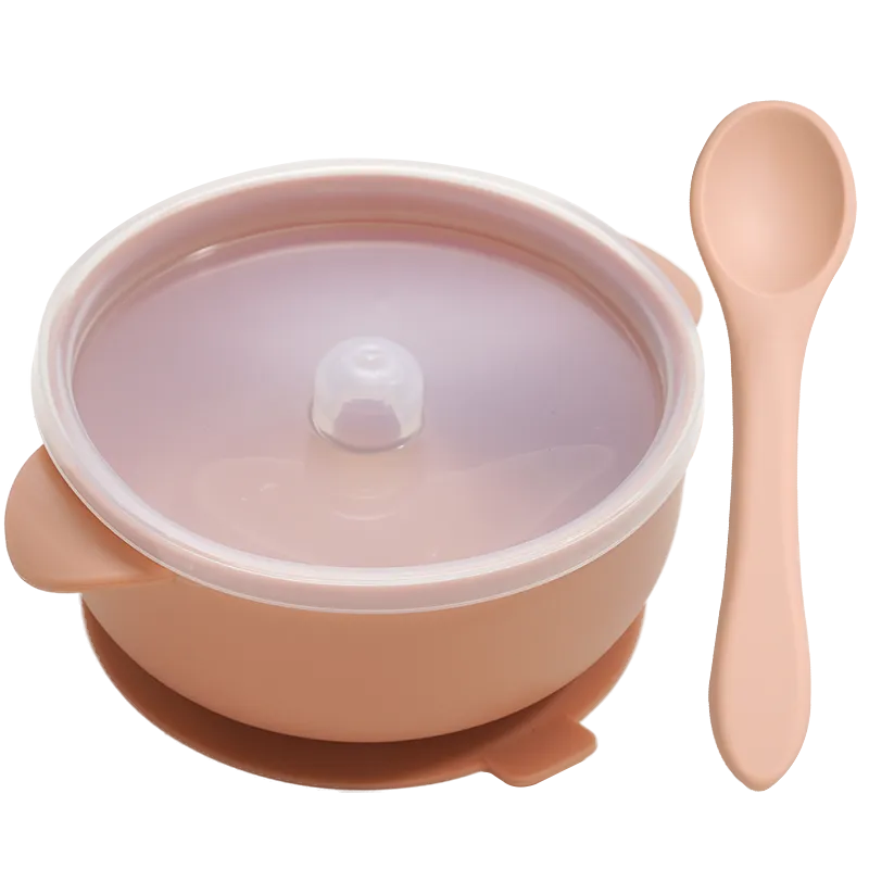 Baby's first solids: BPA-free silicone bowl and spoon filled with mashed fruit, promoting self-feeding