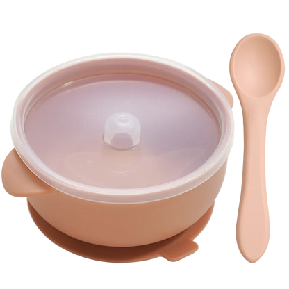 Baby's first solids: BPA-free silicone bowl and spoon filled with mashed fruit, promoting self-feeding