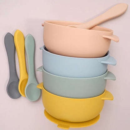Purple BPA-free silicone baby feeding bowl set including a suction base, lid, and soft spoon for infant feeding