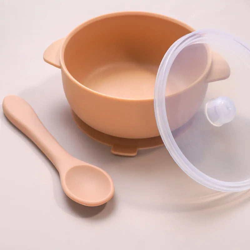 Set of three colorful BPA-free silicone baby bowls with lids and spoons, perfect for baby feeding and travel