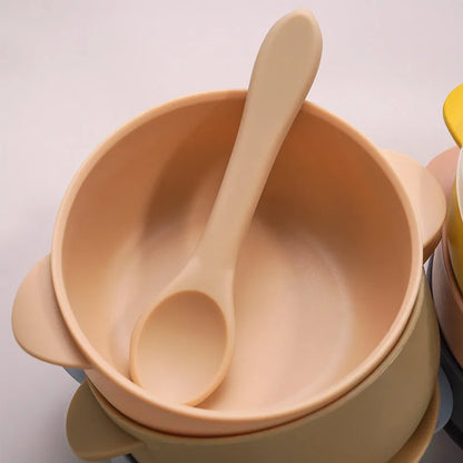 Nursery table with BPA-free silicone baby feeding bowl and spoon, ready for a toddler's mealtime
