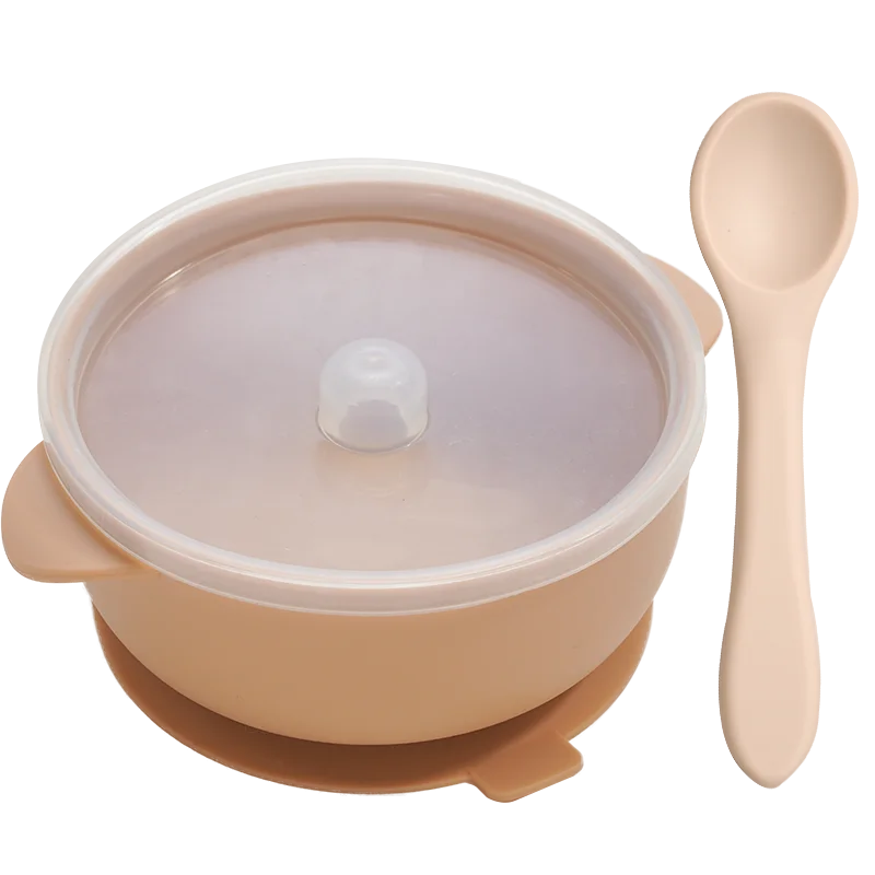 BPA-free silicone baby feeding bowl with a strong suction base preventing spills, in a modern kitchen setting