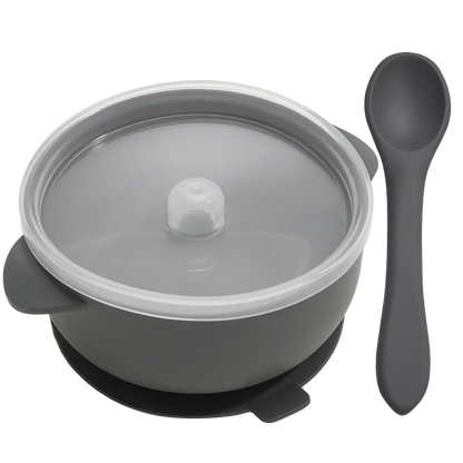 Top-down view of a complete BPA-free silicone baby feeding set: bowl, lid, and spoon, neatly arranged