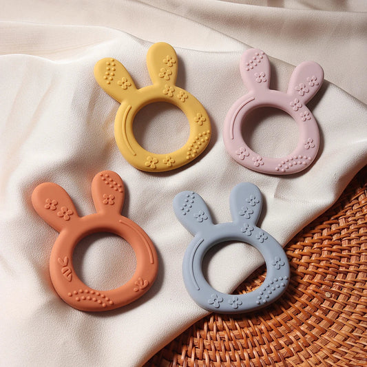 BPA-free silicone baby teether shaped like a cute orange carrot with a playful bunny head, for infant teething relief