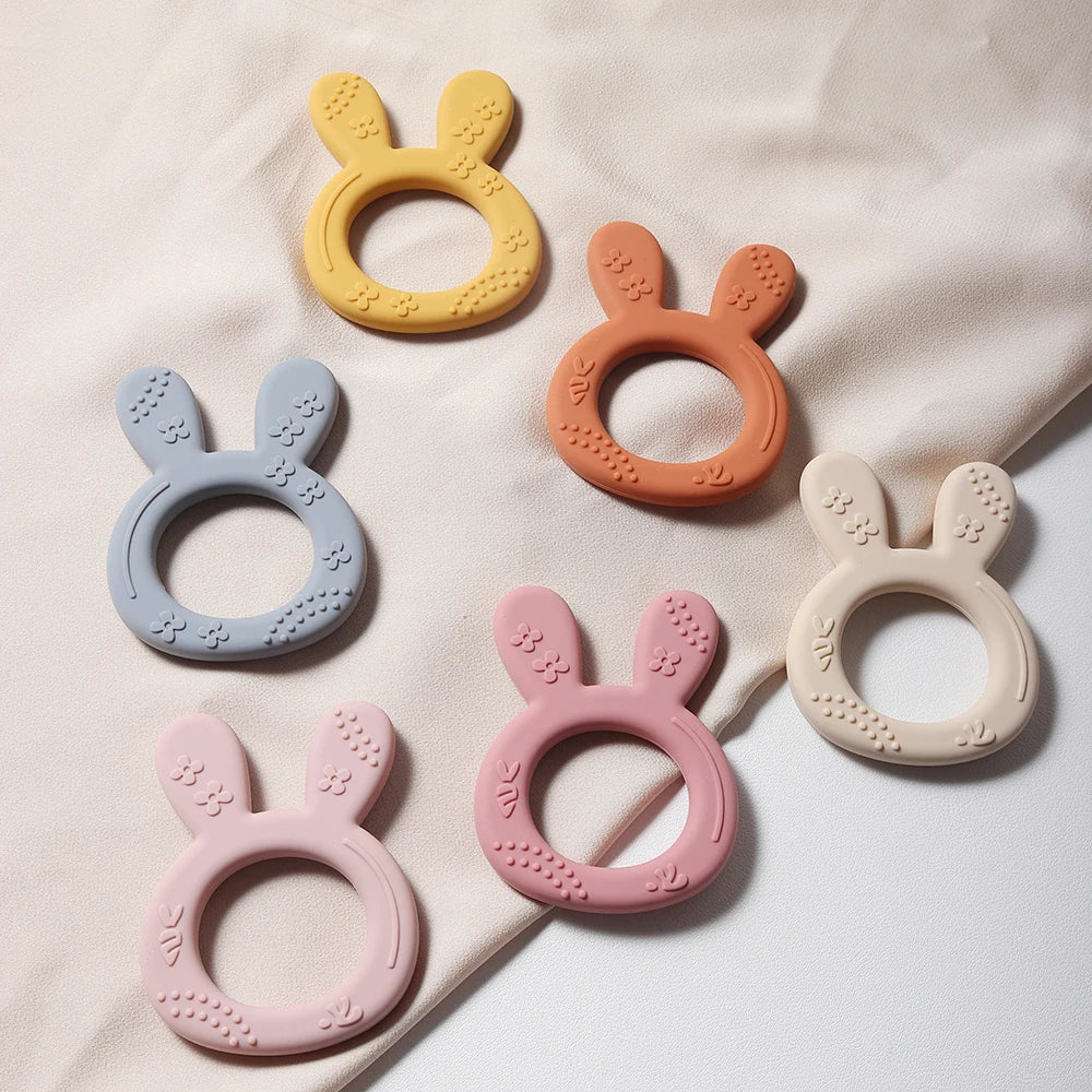 Soft, food-grade silicone baby teether with a carrot and bunny design, ideal sensory infant toy for teething