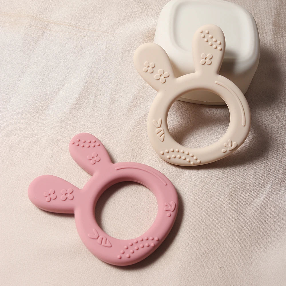 Orange carrot bunny silicone teether, a safe BPA-free infant toy providing teething relief and oral motor stimulation