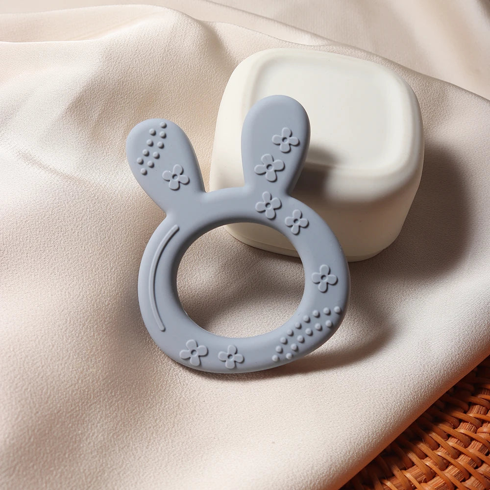 Non-toxic silicone baby teether in a fun carrot bunny shape, an essential BPA-free infant toy for new parents