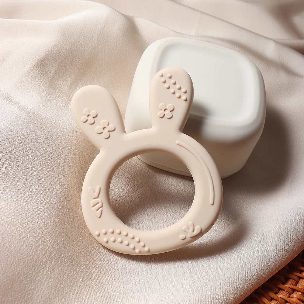 Cute orange carrot and white bunny silicone teether, a gentle BPA-free infant toy for chewing and sensory play