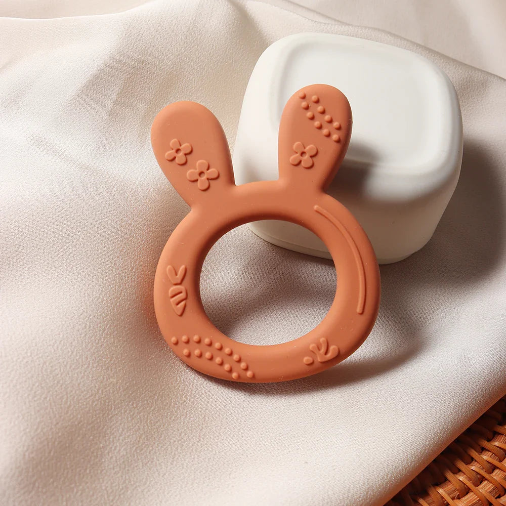 Durable BPA-free silicone baby teether featuring a unique carrot bunny design, excellent for infant oral development