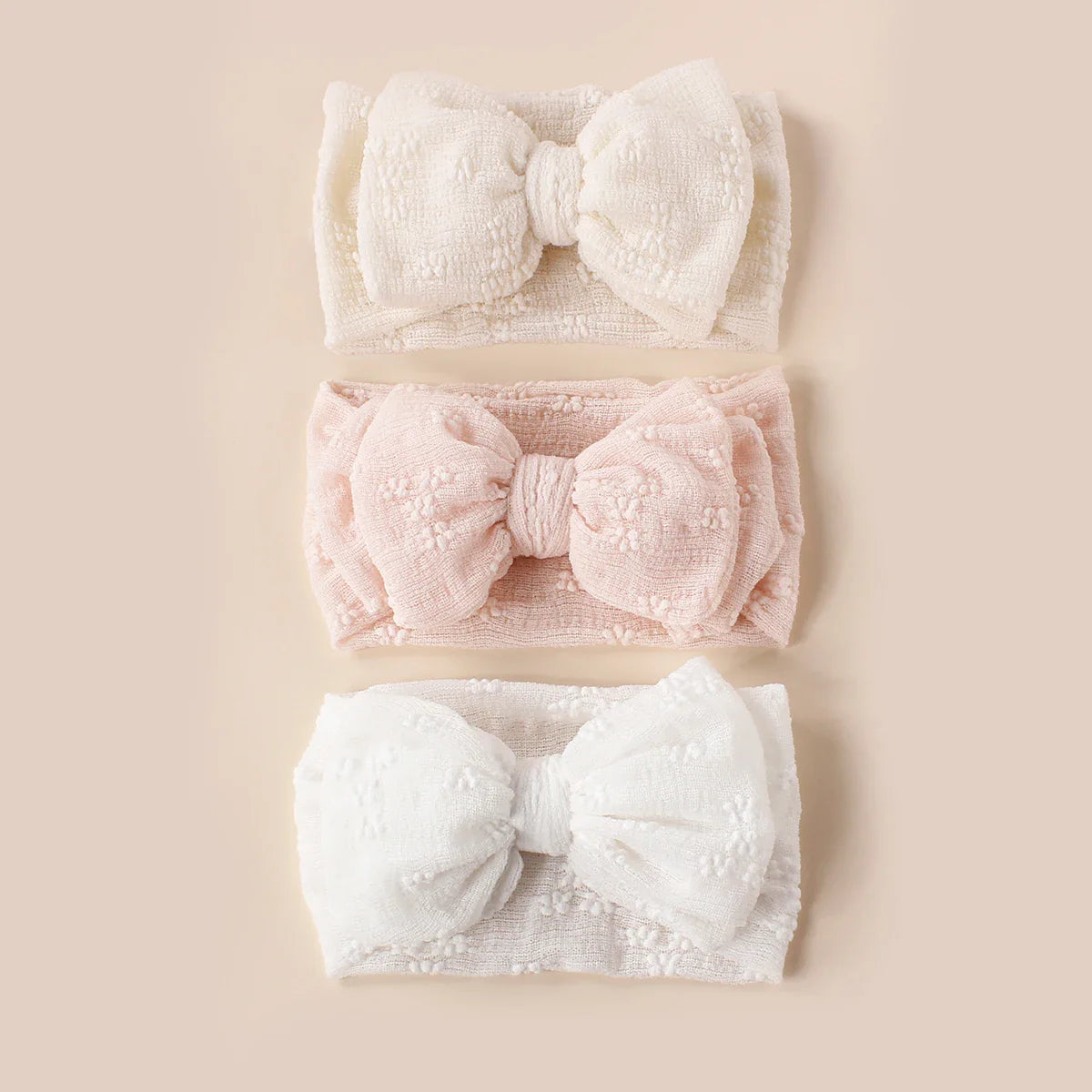Breathable mesh double bow turban headband for infants, soft pink color, cute baby accessory.