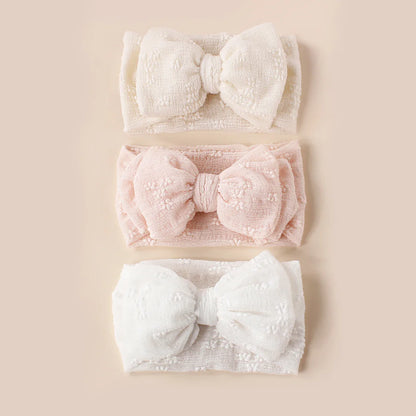 Breathable mesh double bow turban headband for infants, soft pink color, cute baby accessory.