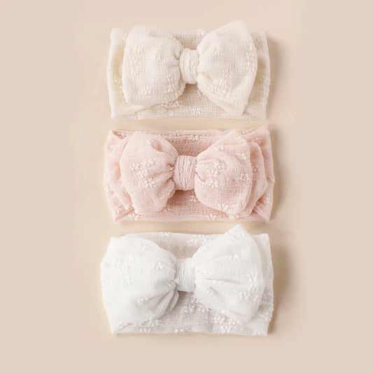 Breathable mesh double bow turban headband for infants, soft pink color, cute baby accessory.