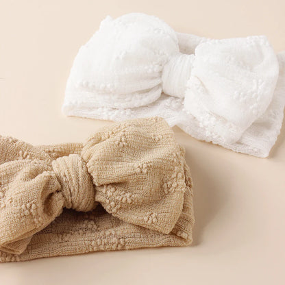 Display of baby breathable mesh double bow turban headbands in various colors, soft headwear.