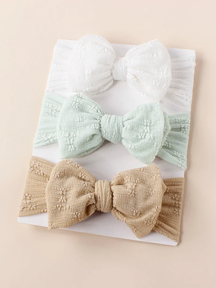 Fashionable baby breathable mesh double bow turban headband in a vibrant yellow.