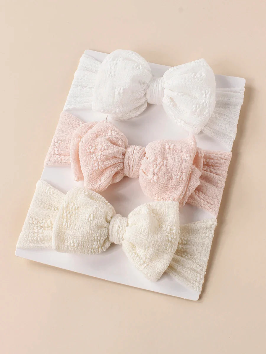 Toddler wearing a cute baby breathable mesh double bow turban headband, infant fashion.