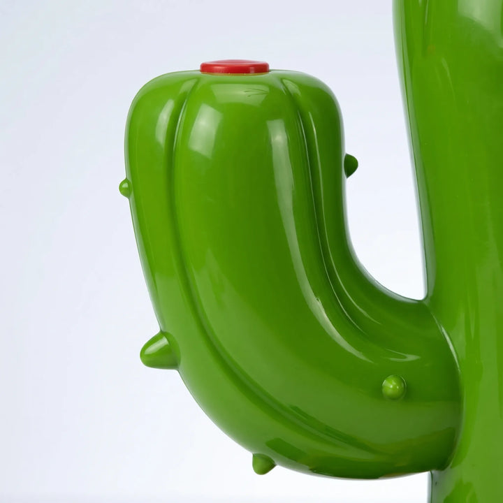 Kids' outdoor water sprinkler shaped like a friendly cactus, perfect for summer garden play & fun.