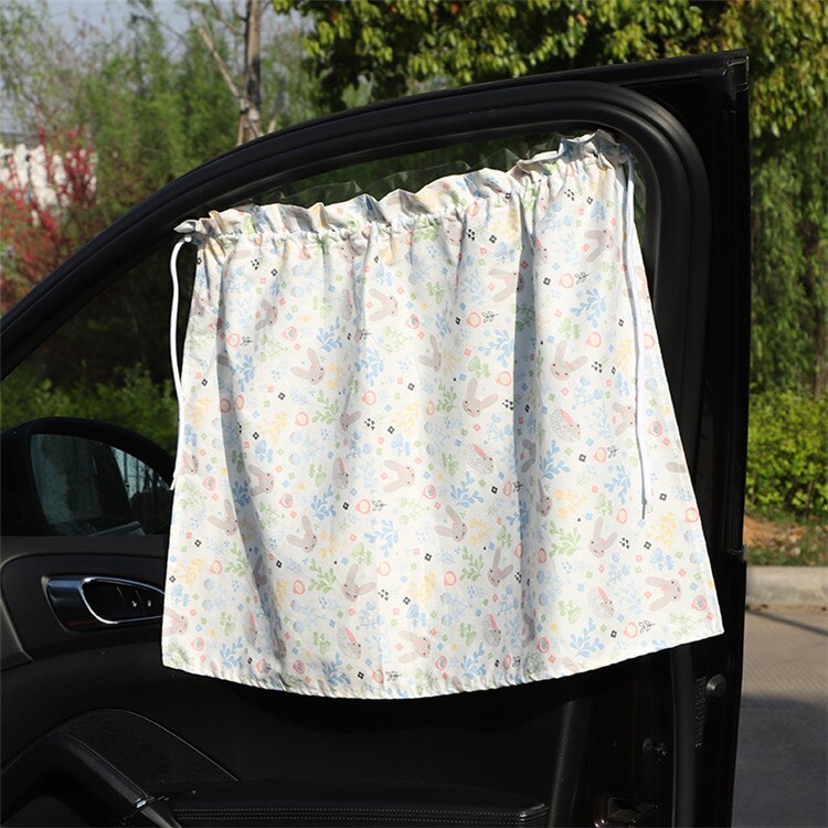 Universal car sunshade with playful cartoon design, protects kids from UV rays during travel