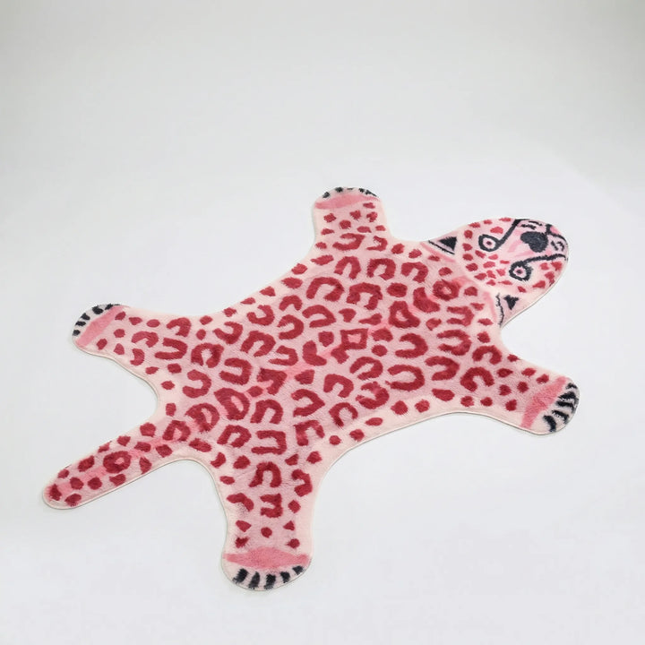 Pink & brown leopard print shaped rug with wavy design. Plush animal print accent rug for cozy and whimsical home decor.