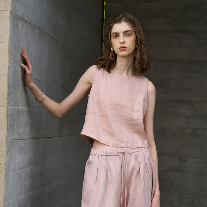 Chic pink women's asymmetric crop top, sleeveless & comfortable for summer casual wear. Relaxed fit.